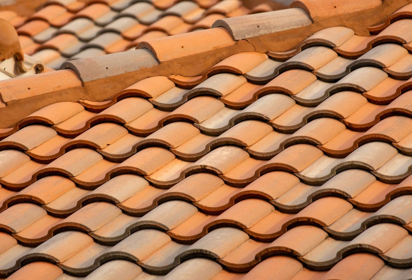 Close view of overlapping terracotta barrel roof tiles